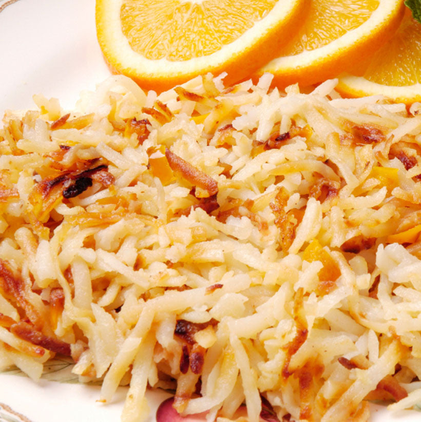 Crispy hash brown potatoes served with orange slices