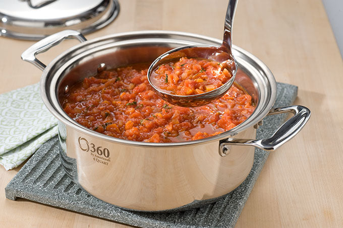 A pot of marinara sauce with a ladle, showcasing the recipe's ingredients and preparation.