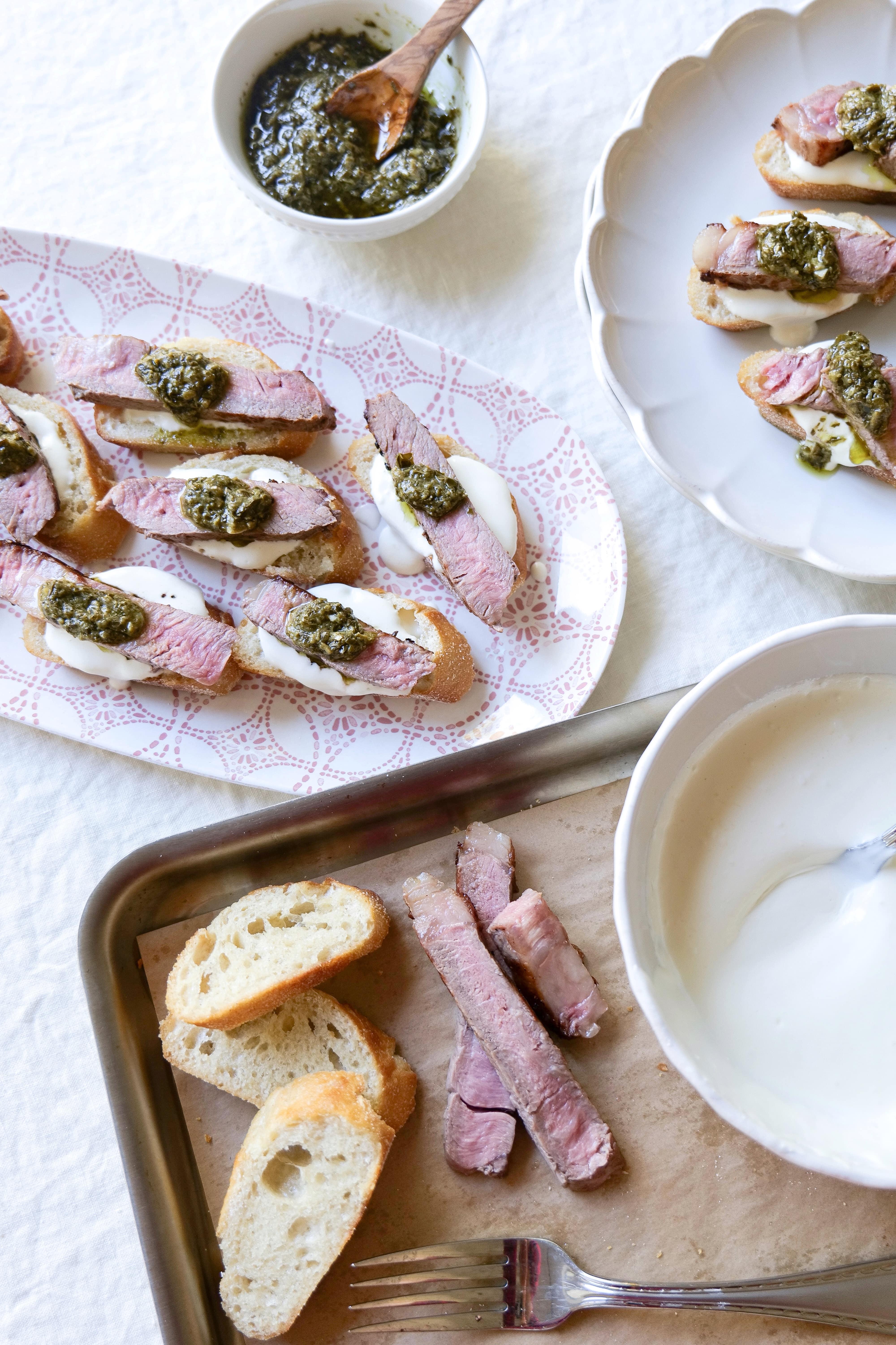 Platter of Steak & Feta Crostini with pesto and a bowl of Greek yogurt