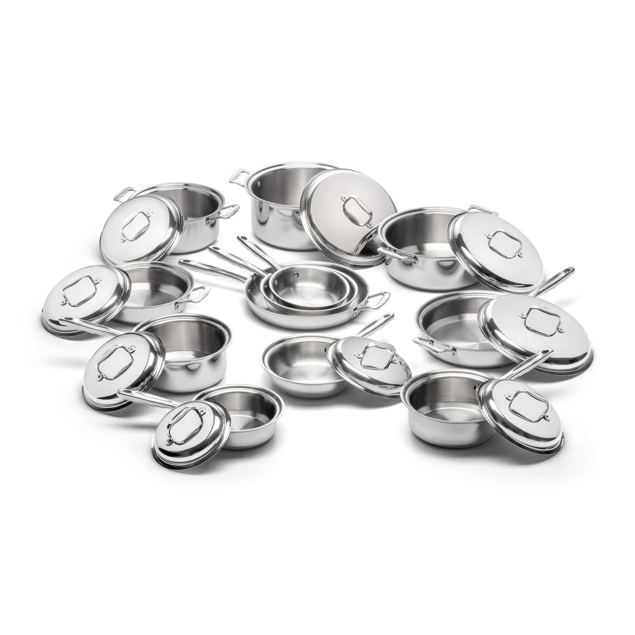 A collection of stainless steel cookware including pots and lids arranged together.