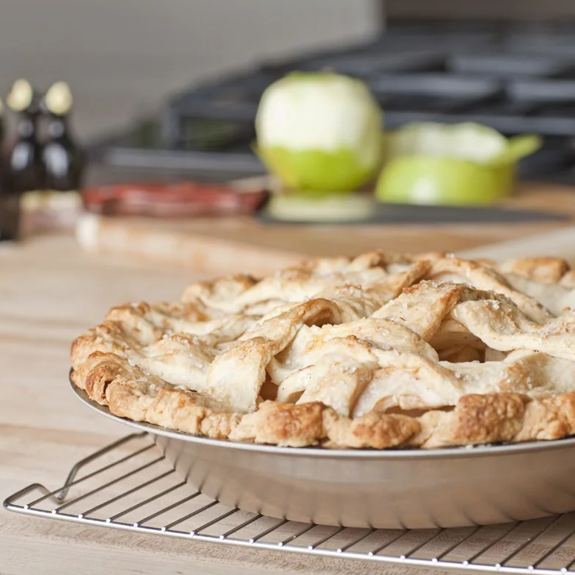A freshly baked pie cooling on a rack in a kitchen setting.