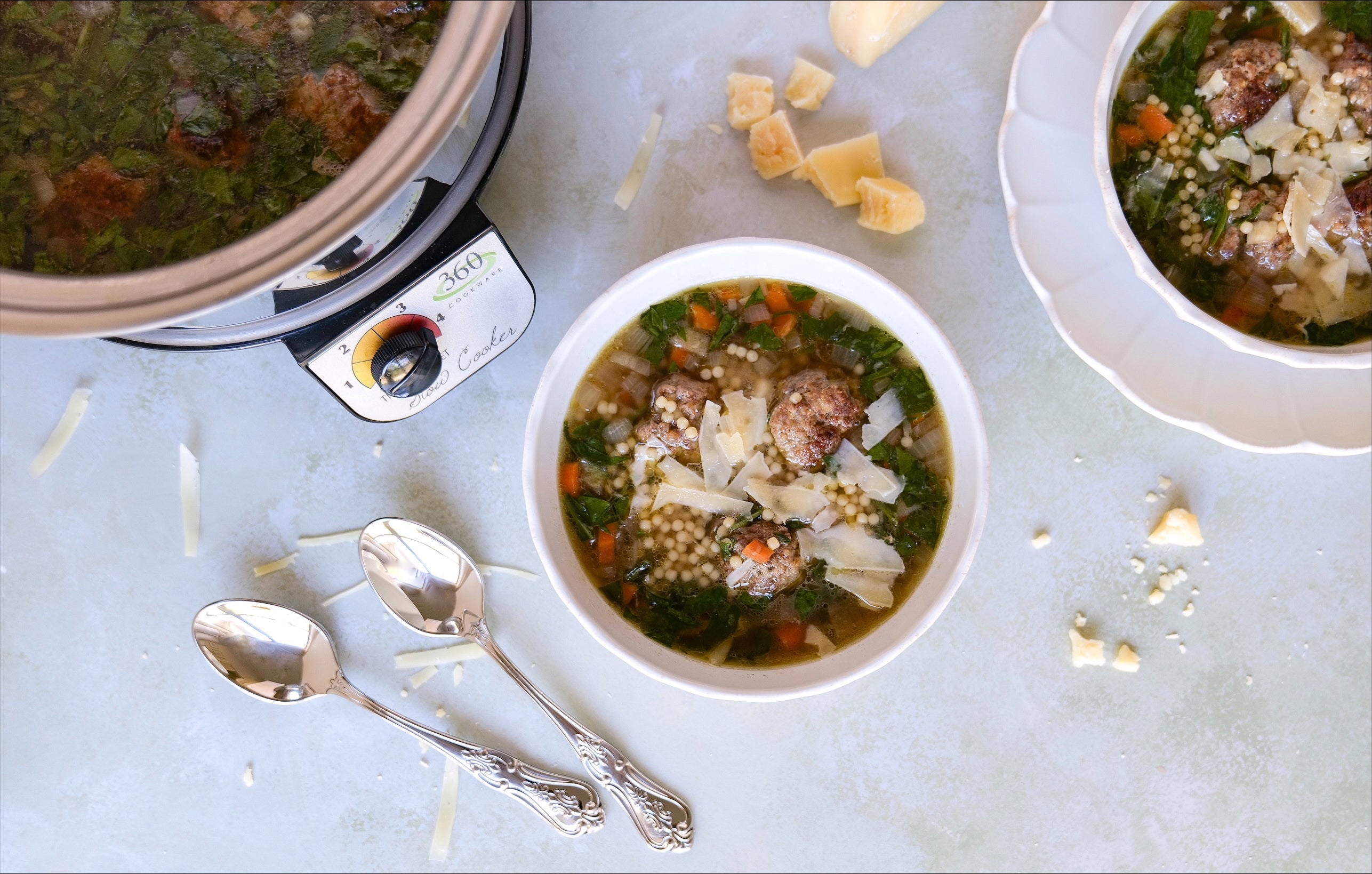 Bowl of Slow Cooker Italian Wedding Soup with meatballs, vegetables, and cheese