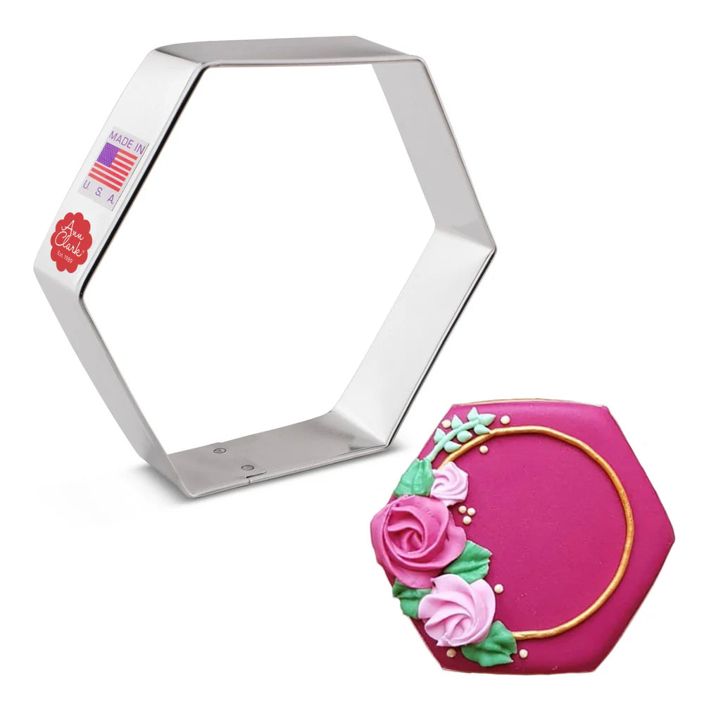 Hexagon cookie cutter with decorated cookie featuring pink roses