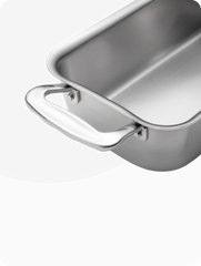 Close-up of ergonomic handles on stainless steel cookware, showcasing craftsmanship.