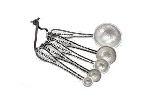 Set of stainless steel measuring spoons with measurements labeled