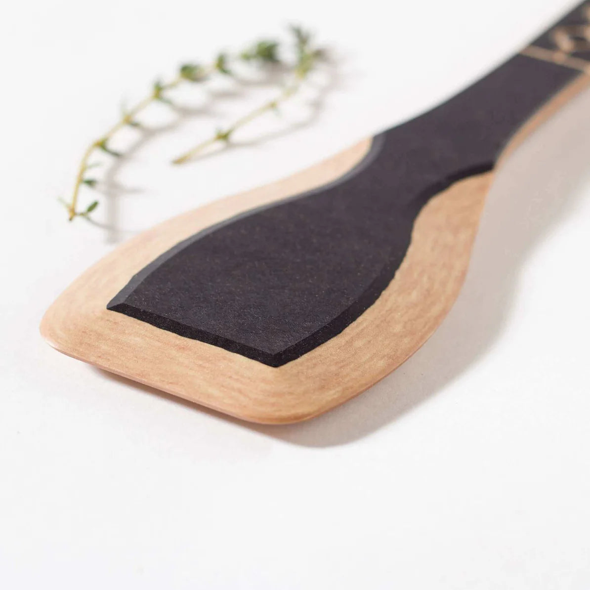 Frank Lloyd Wright Paddle with black surface and wooden handle