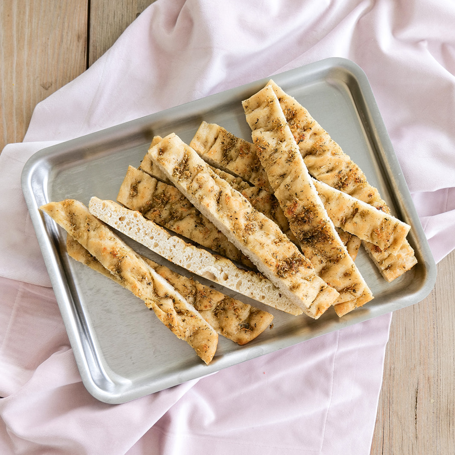 Baked breadsticks on a stainless steel jelly roll pan