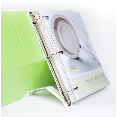 Open 360 Cookbook with a green binder and a stainless steel pot on the cover, titled 'USE & CARE GUIDE'.