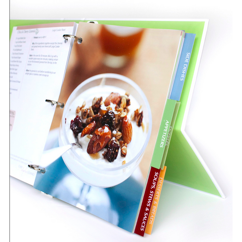 Open cookbook page featuring a dessert with nuts and dried fruits