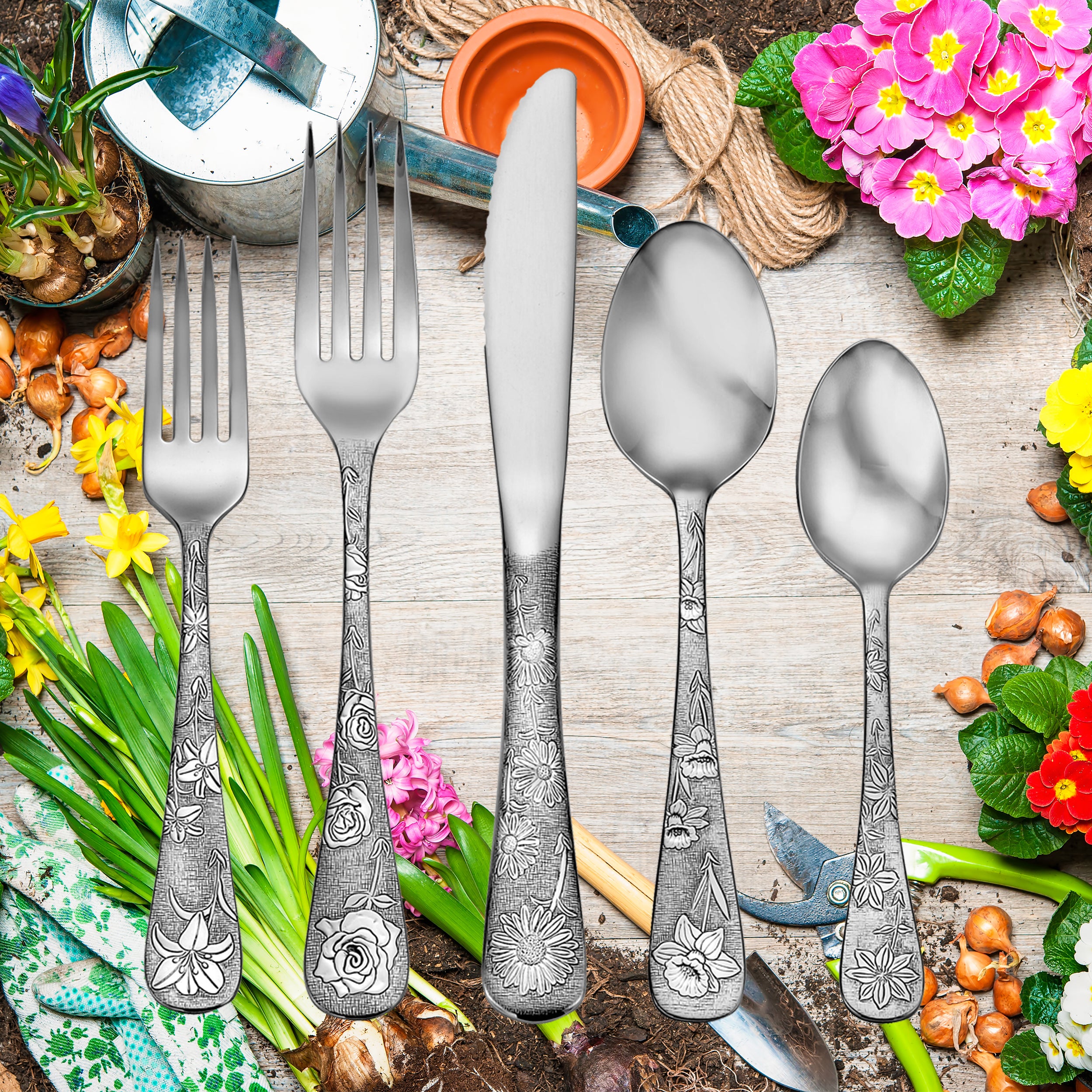 Five pieces of American Garden flatware with floral designs on handles, set against a garden background.