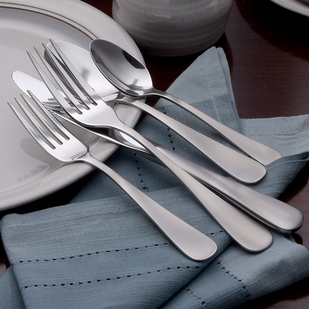 Satin Annapolis 45 Piece Set displayed with forks and spoons on a table setting