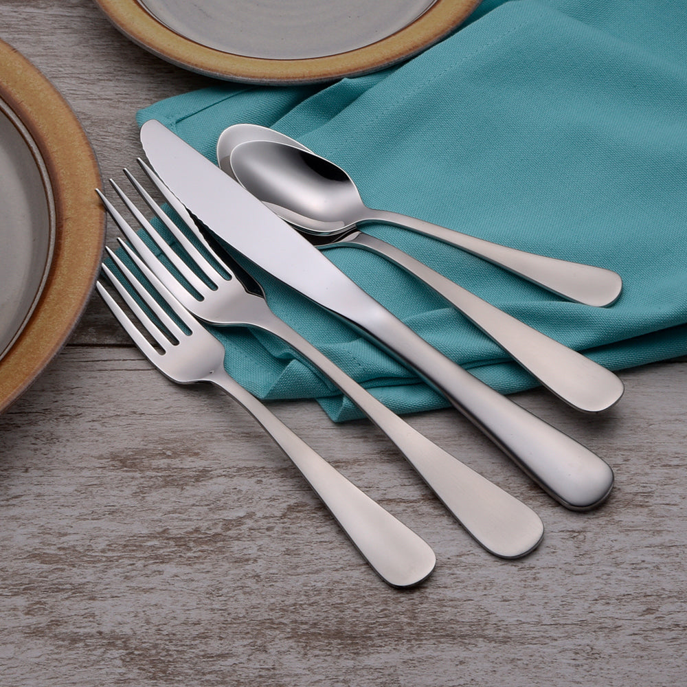 Stainless steel cutlery set on a turquoise napkin