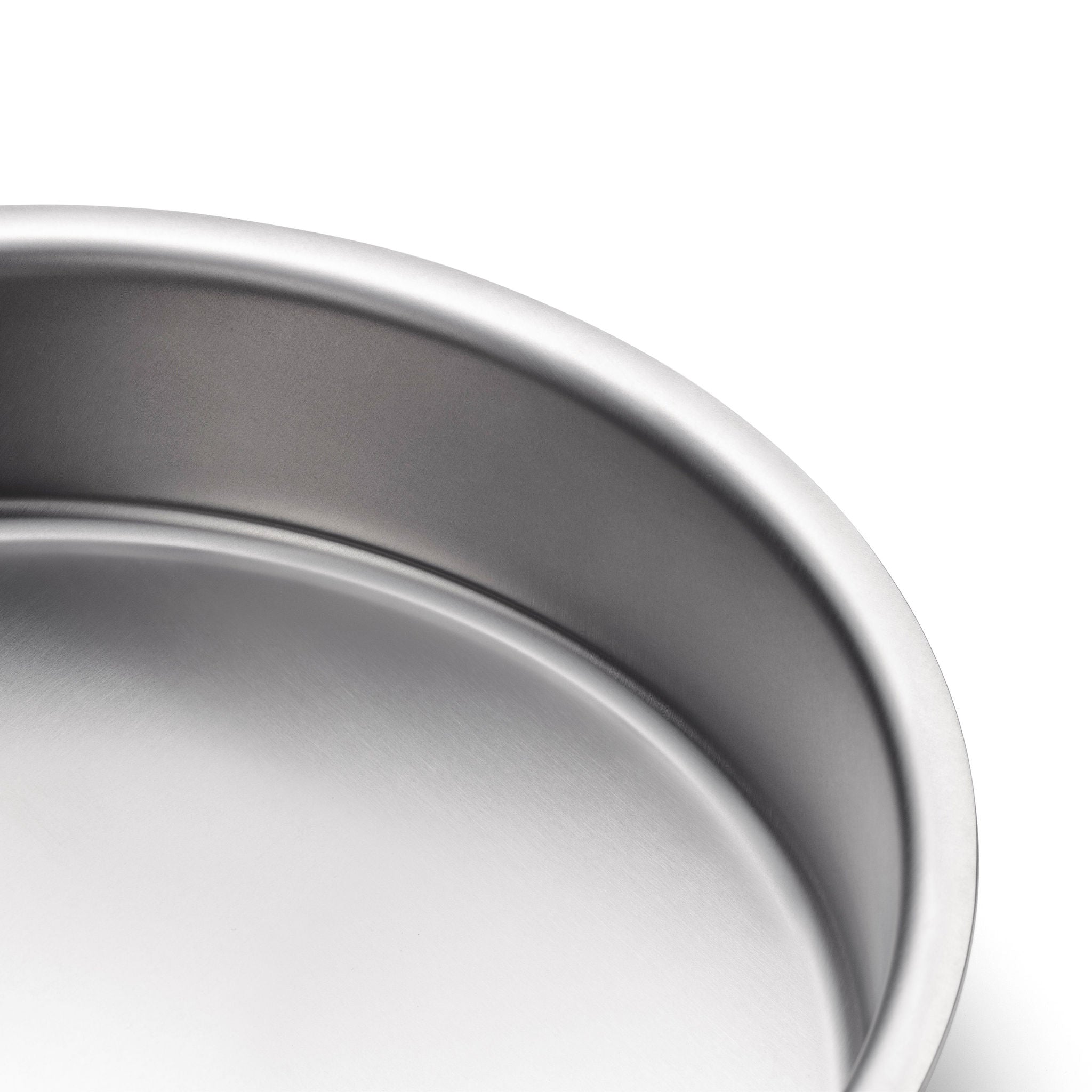Close-up of a durable 9" round stainless steel cake pan with no handles.