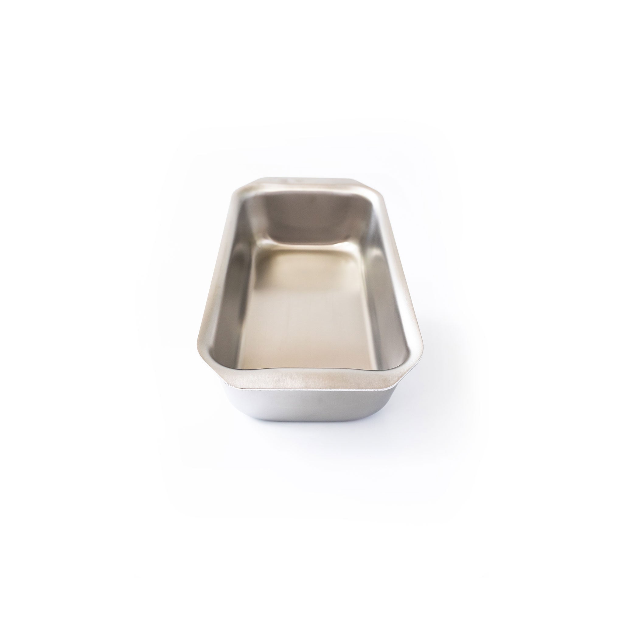 Stainless steel loaf pan with tab handles, designed for even heating.