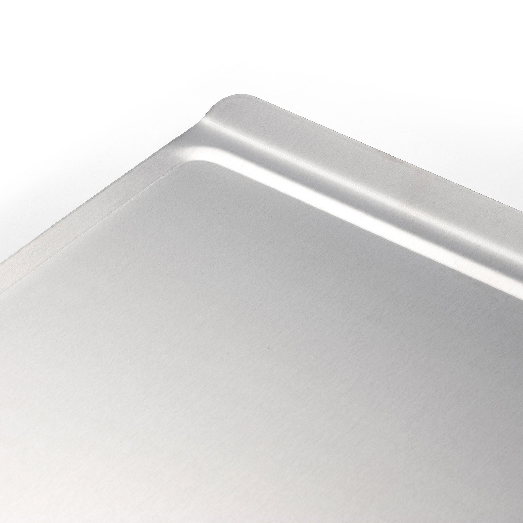Close-up view of a medium stainless steel cookie sheet with a multi-layer design.