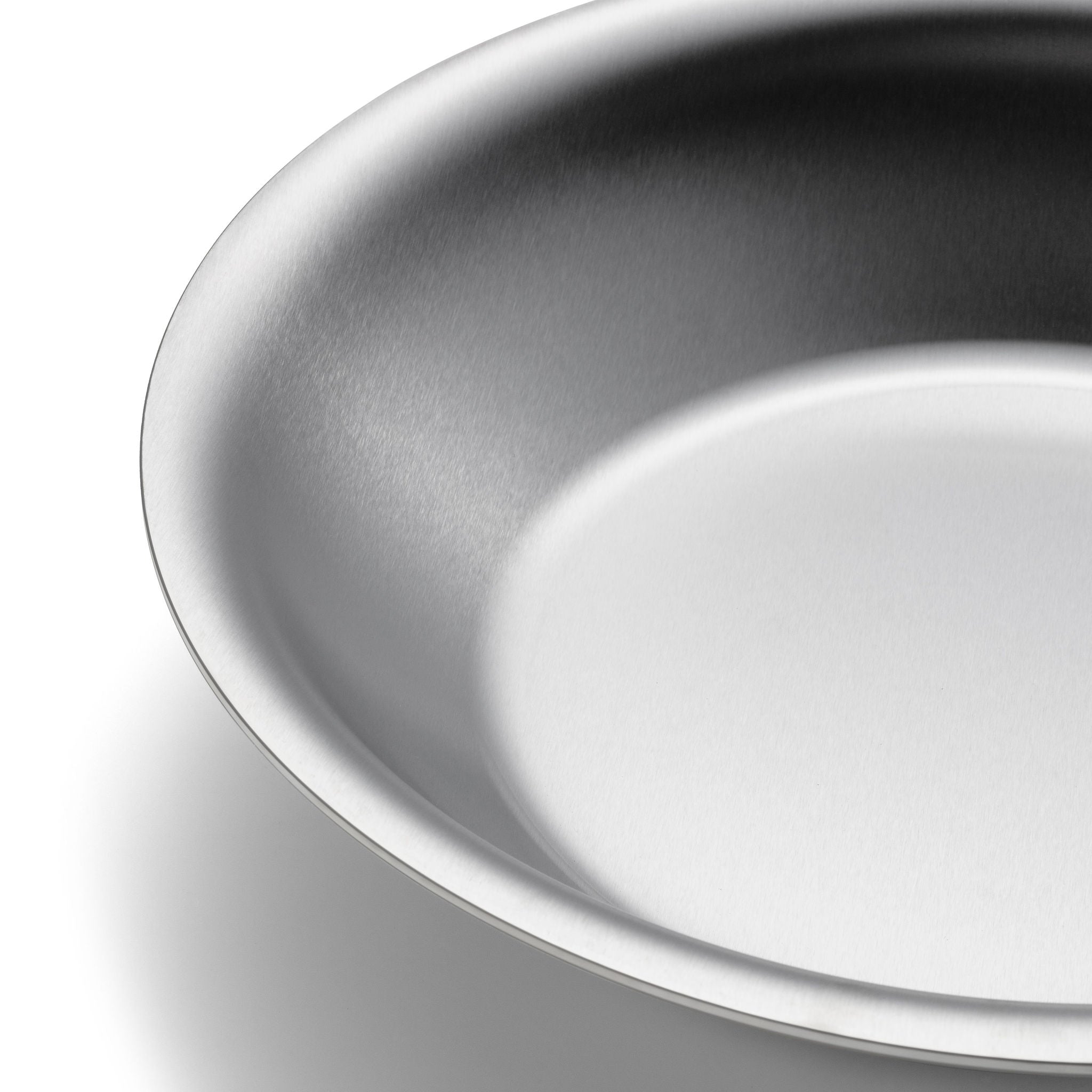 Close-up of a 12" stainless steel oven-to-table pan with a smooth surface