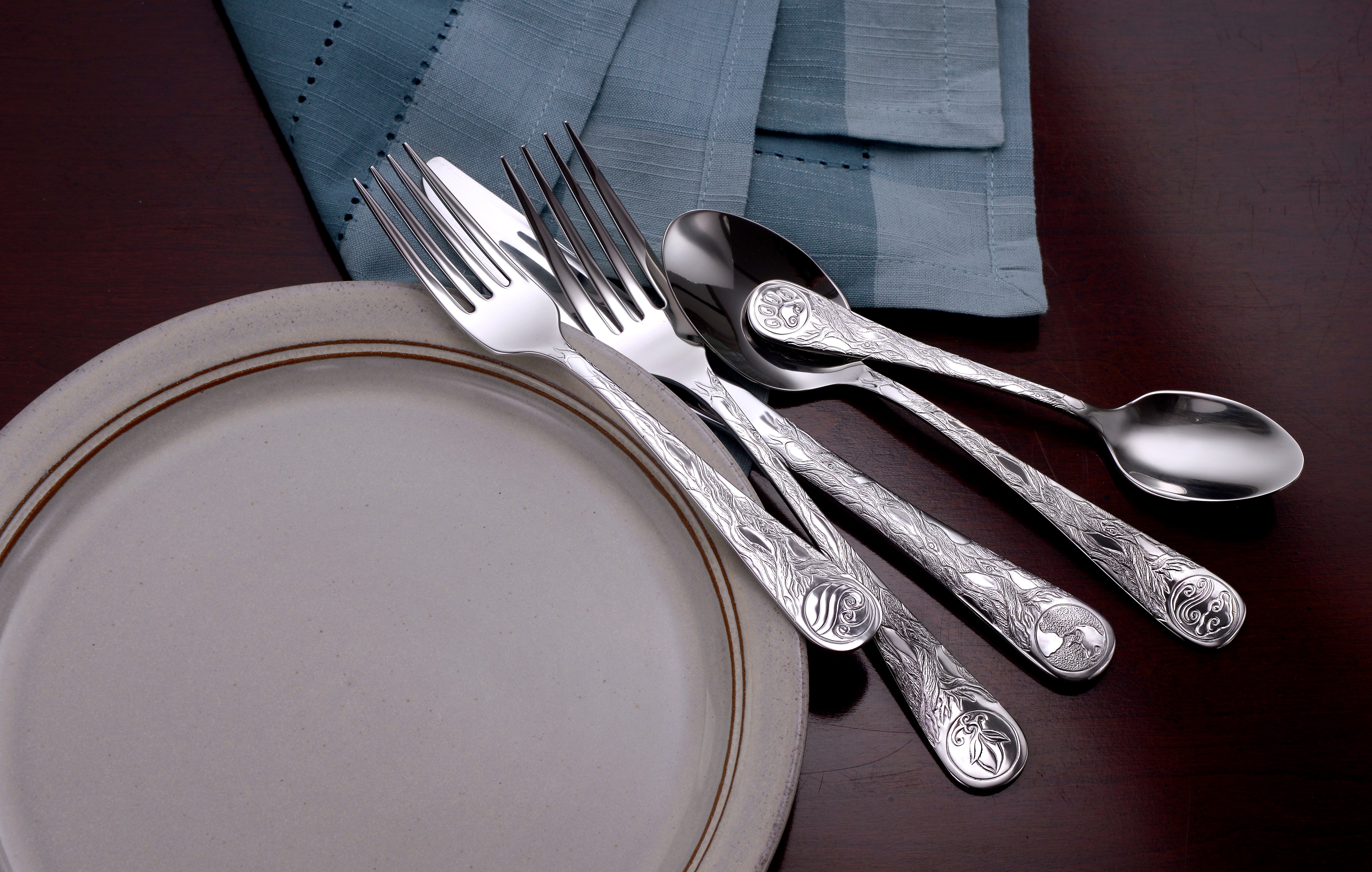 Earth Pattern Flatware set displayed on a plate with utensils arranged on a table