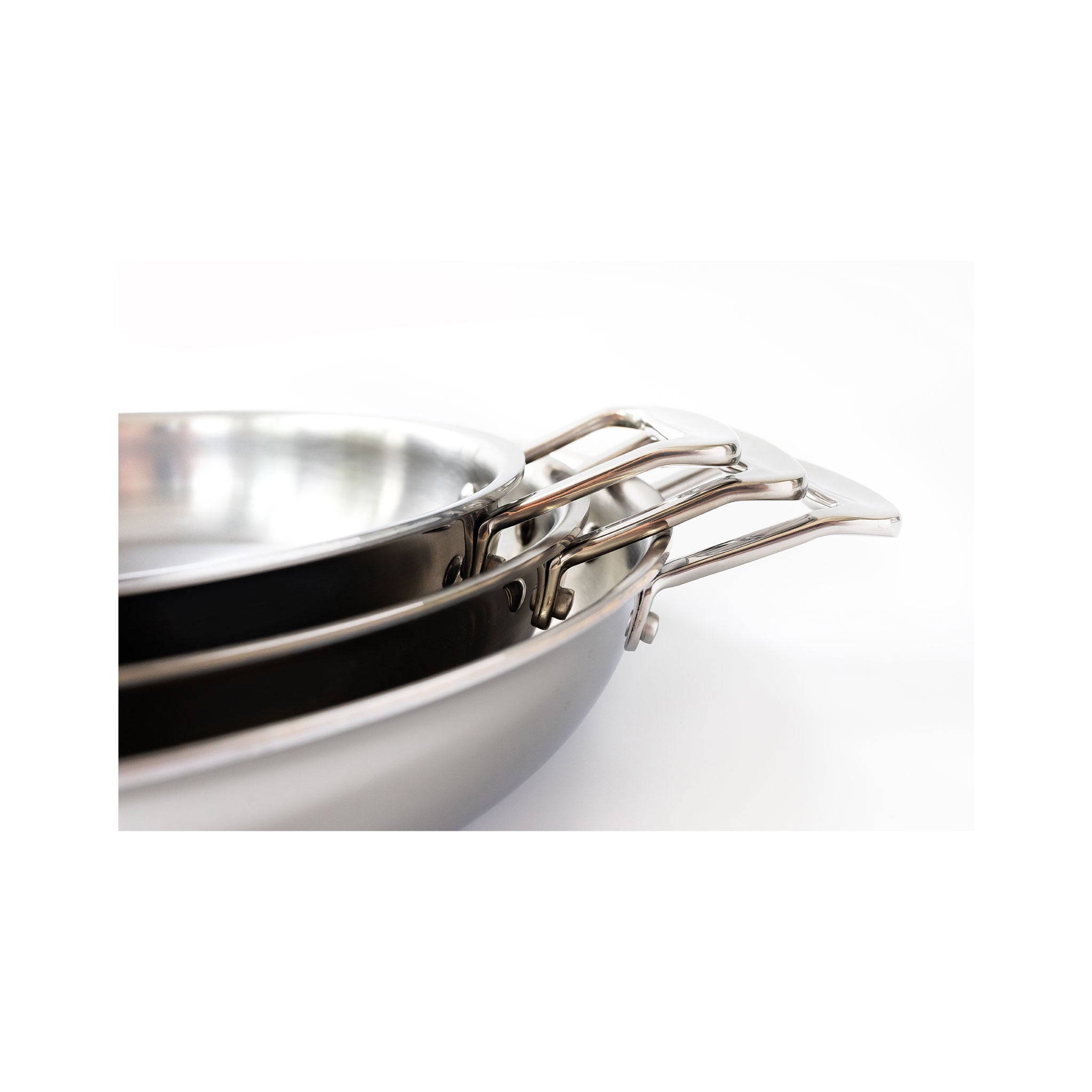 Three stackable stainless steel fry pans with short handles.
