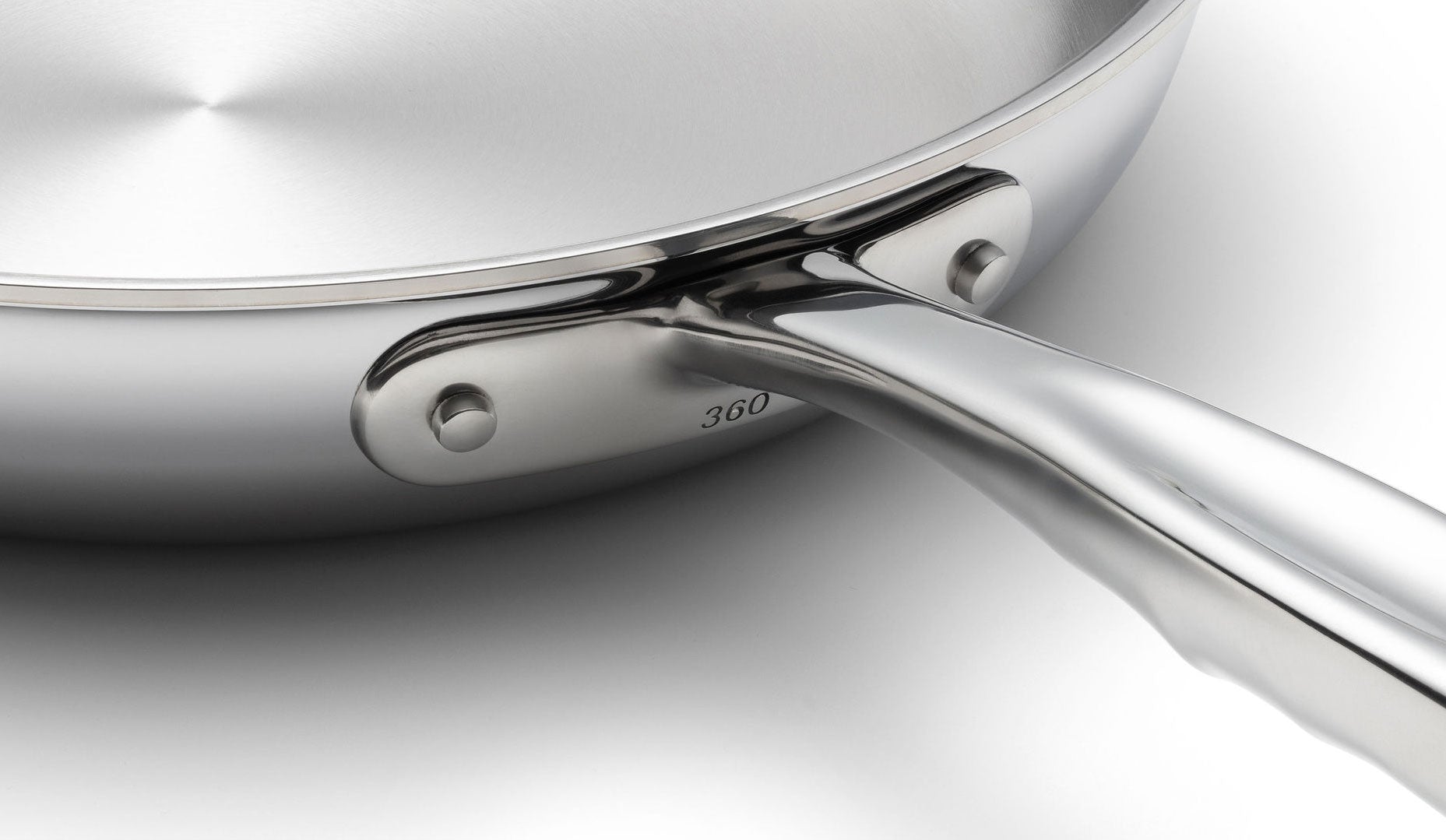 Close-up of a stainless steel sauté pan with a polished handle and '360' engraved on the side.