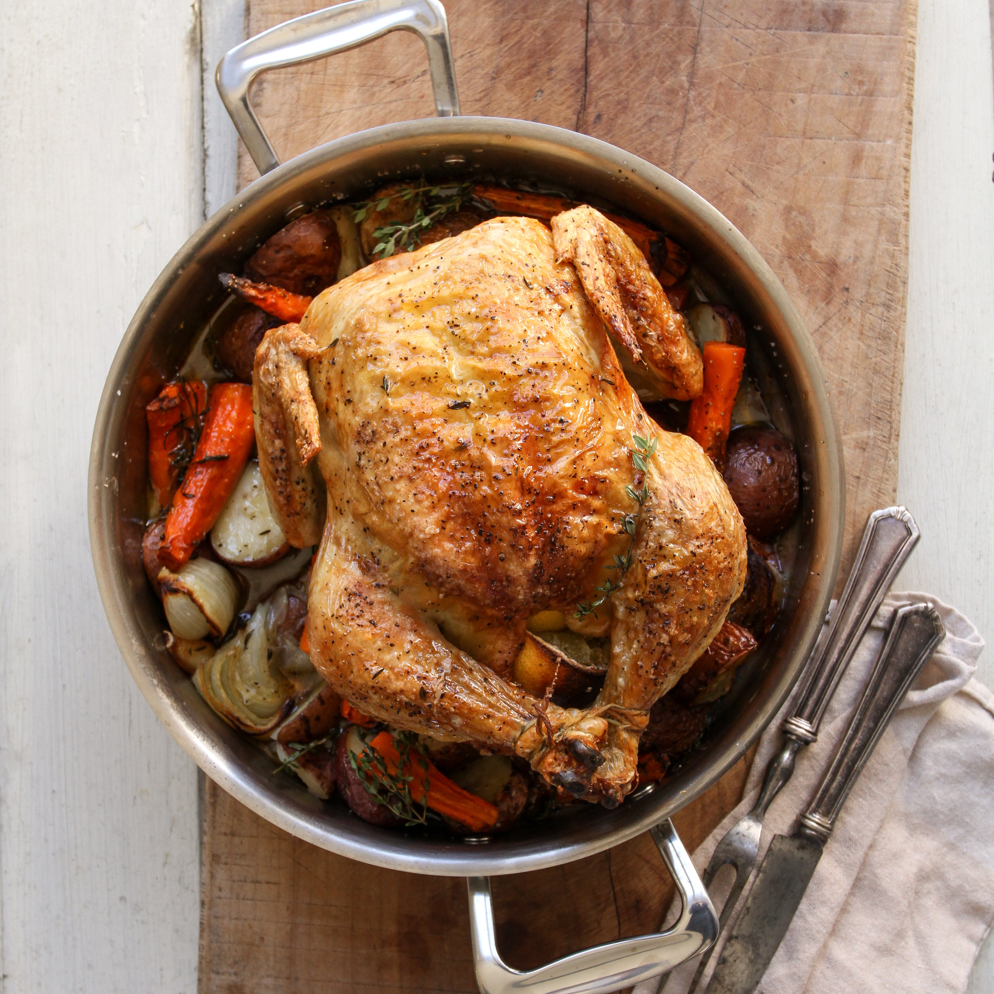 A 3-in-1 roasting pan with a roasted chicken and vegetables inside.