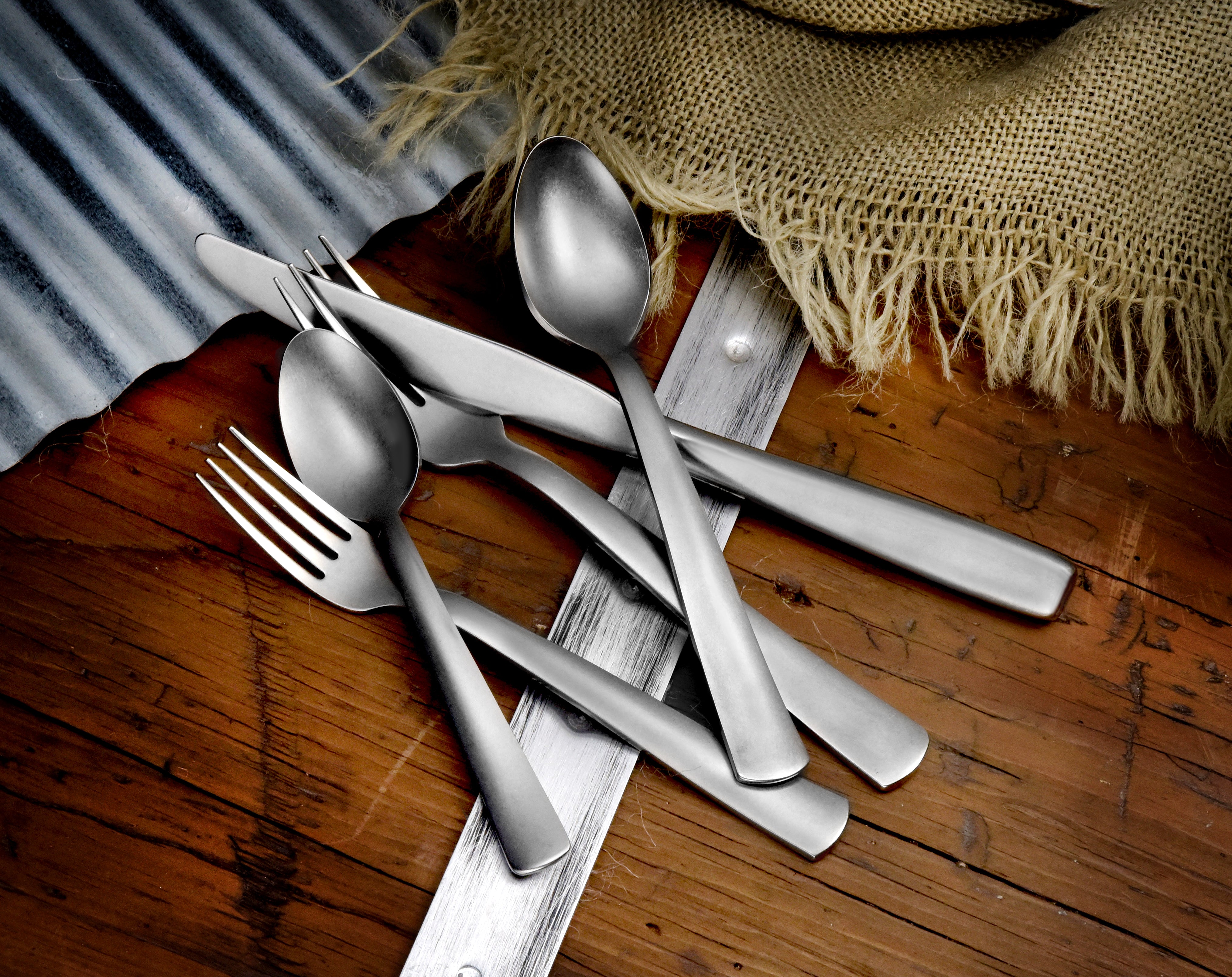 American Industrial 45 Piece Set featuring stainless steel cutlery on a wooden surface