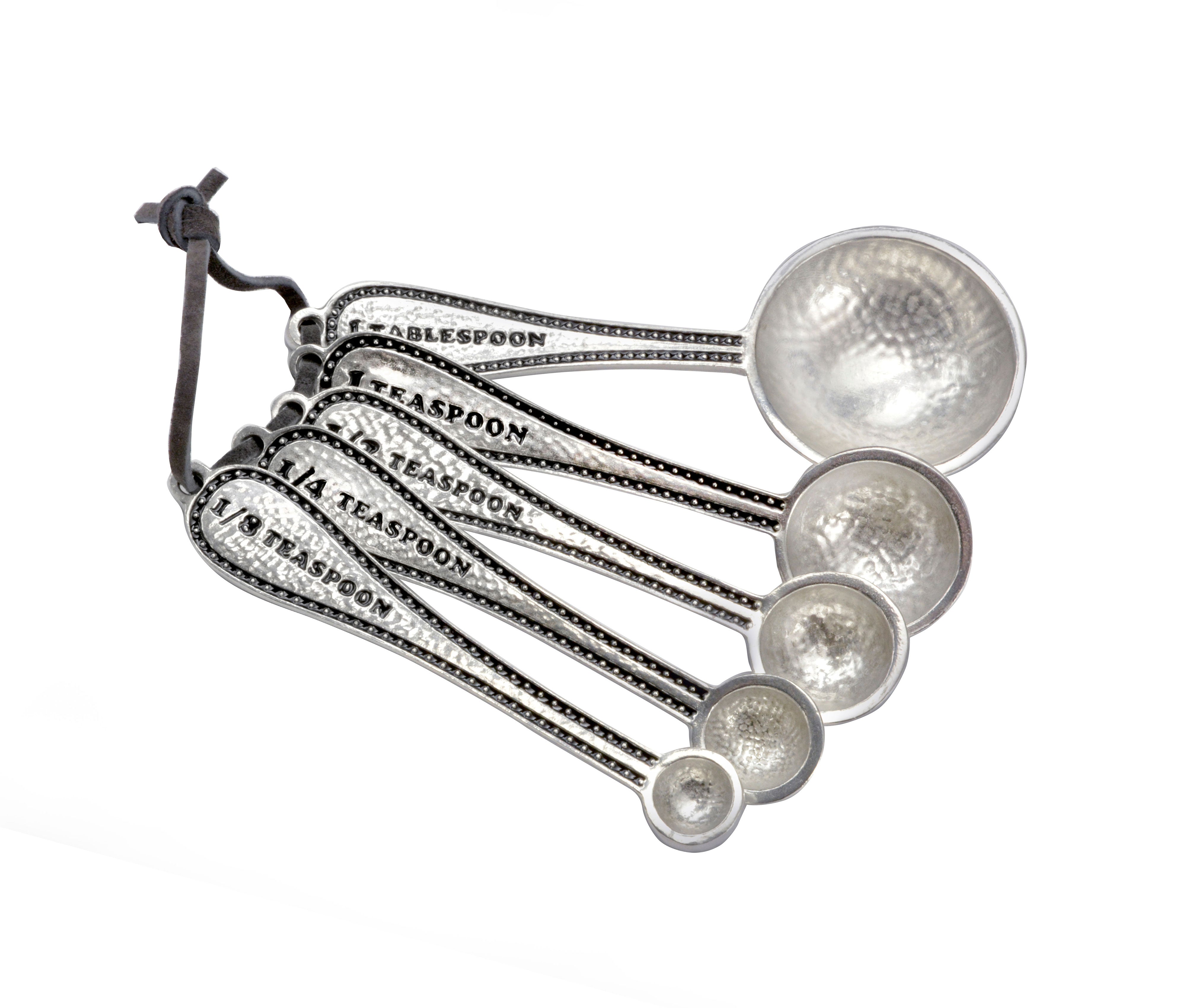 Set of five measuring spoons with engraved measurements: 1 tablespoon, 1 teaspoon, 1/2 teaspoon, 1/4 teaspoon, and 1/8 teaspoon.